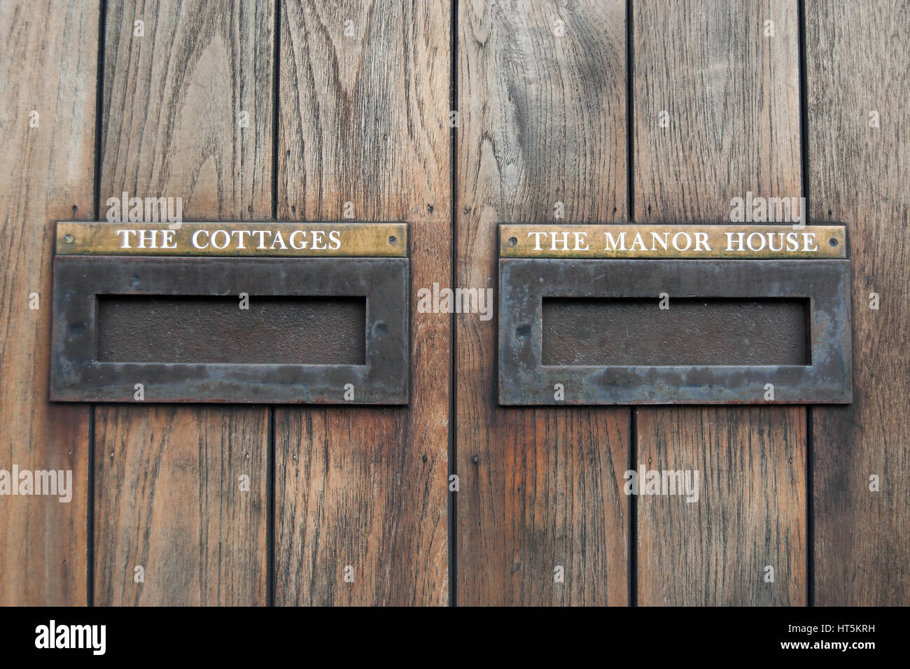 letter boxes in wooden gate labelled the cottages and the manor house, in ham, surrey, england Stock Photo