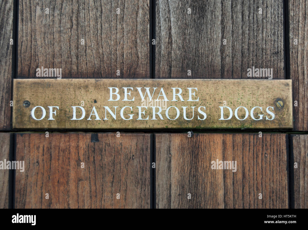 beware of dangerous dogs sign, on a wooden gate in ham, surrey, england