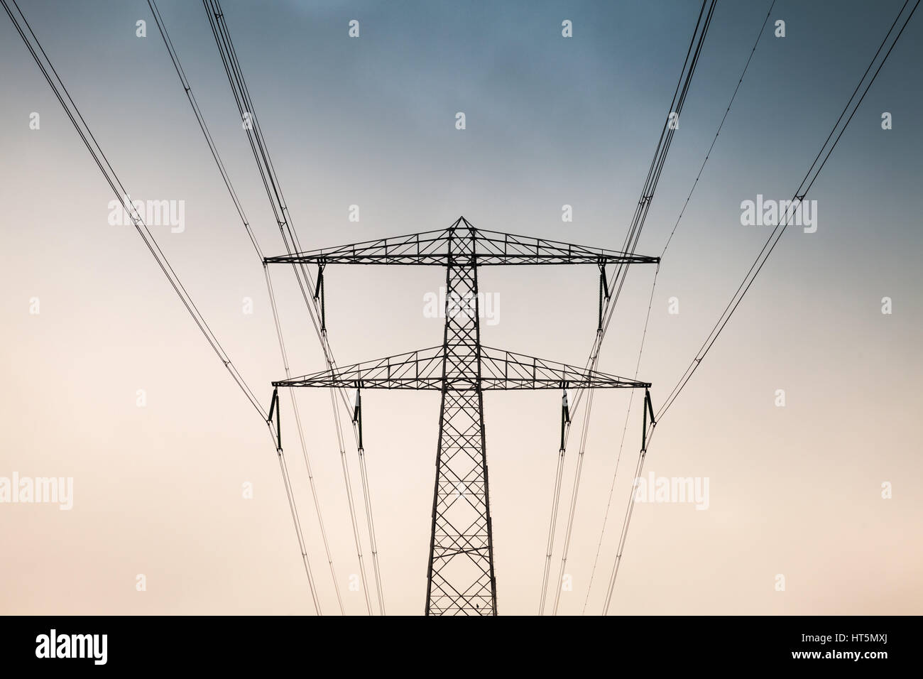 Transmission power tower, electricity pylon, front view. Steel lattice tower, used to support an overhead power line Stock Photo