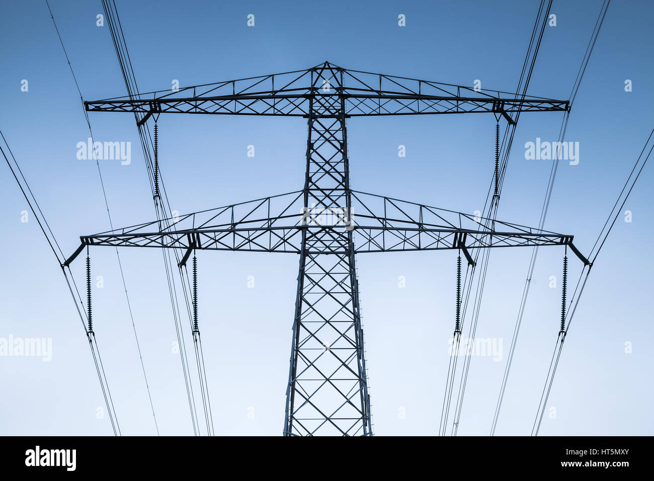 Transmission power tower, electricity pylon fragment. Steel lattice tower, used to support an overhead power line Stock Photo