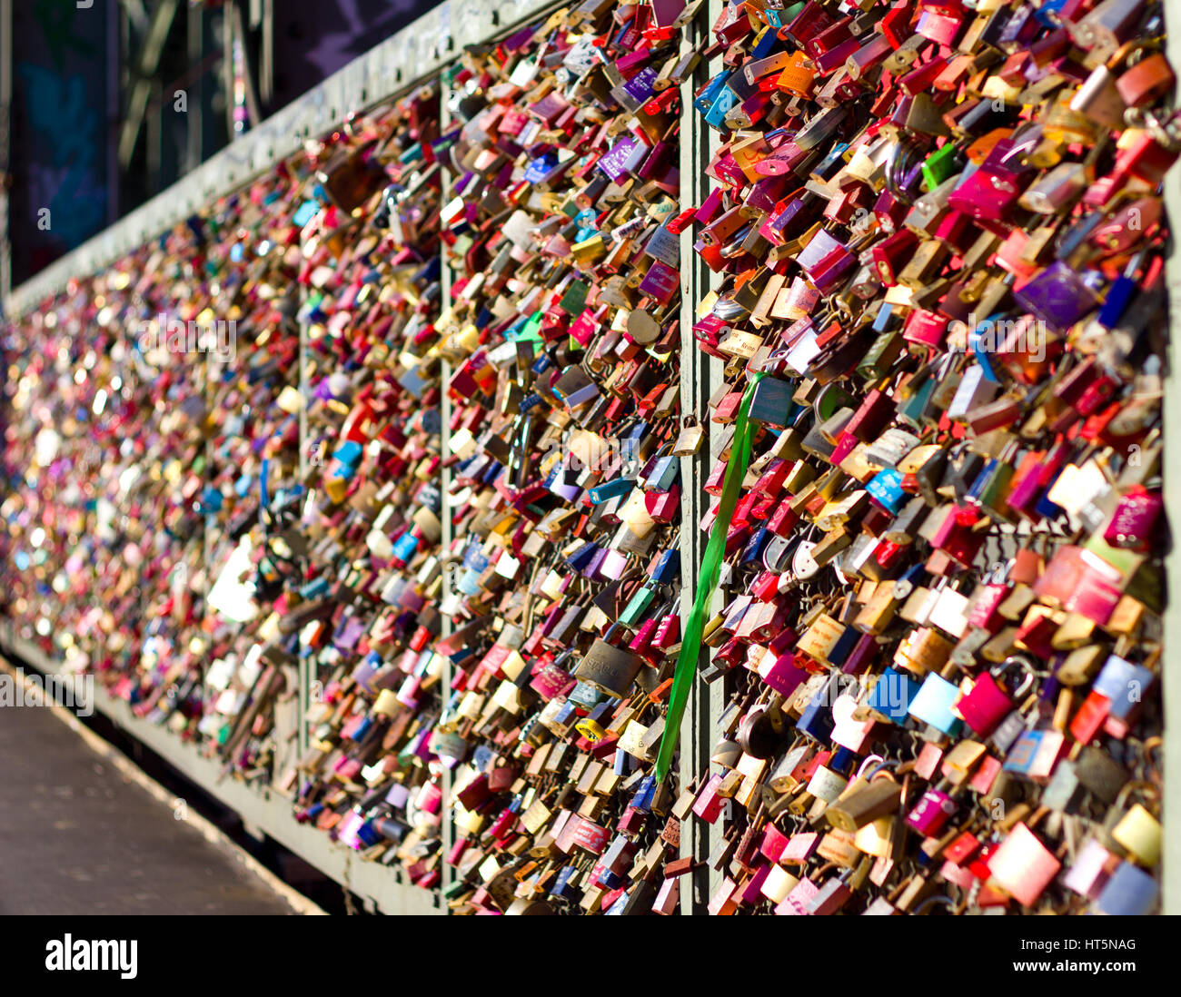 The iconic 'Love Lock' bridge of Cologne, Germany shimmers in the morning sun. Stock Photo