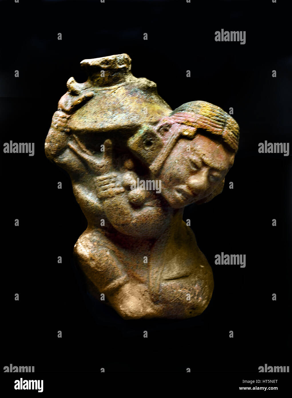 A figure supported on a knee, lifting a jug on his shoulder. Guatemala Maya (Culture)  13 x 9.7 x 7.8 cm The Mayans - Maya Mesoamerican - Pre Columbian civilization  Central America ( 2600 BC - 1500 AD ) American Stock Photo