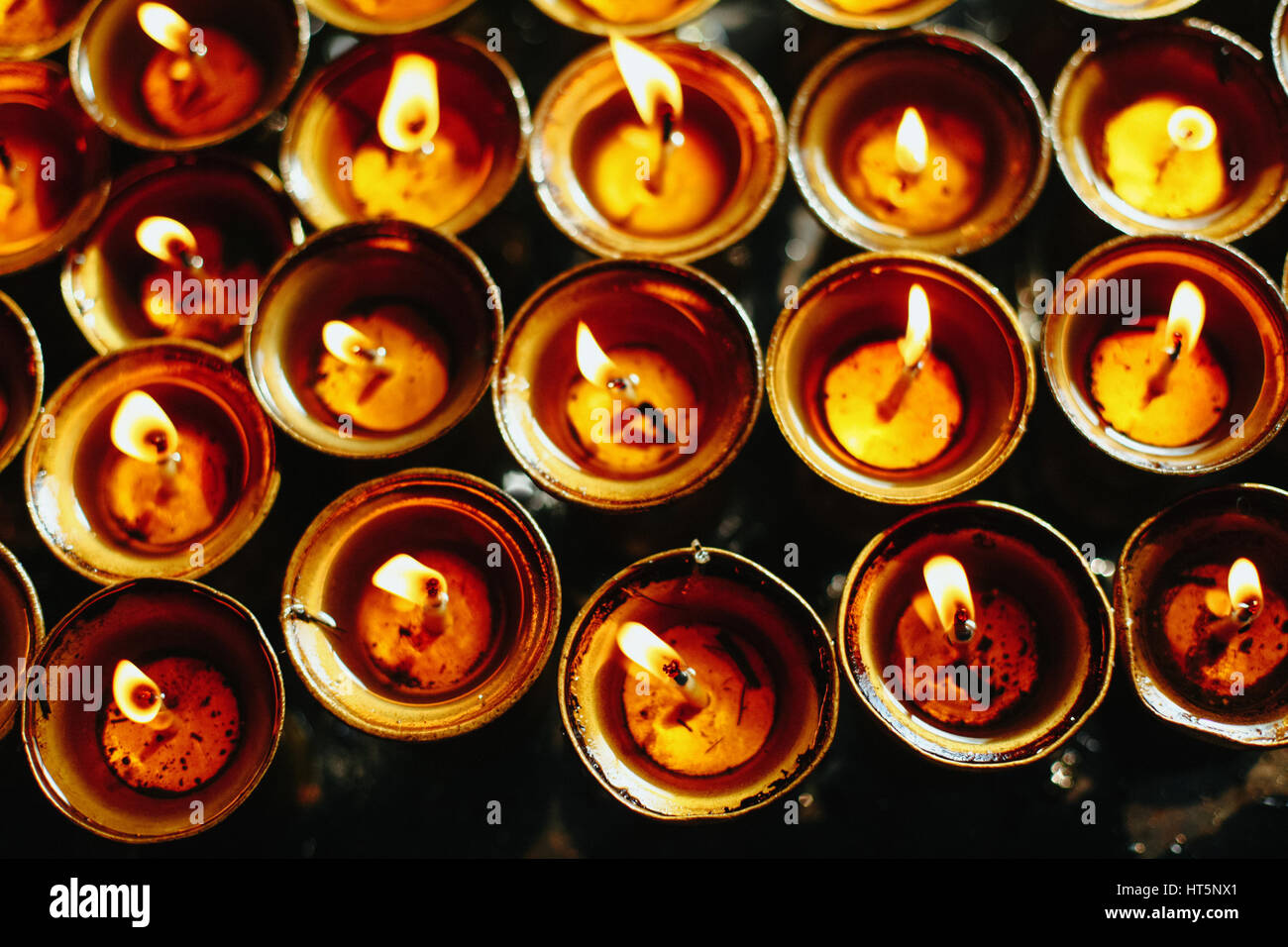 Oil lamps burning in the temple Stock Photo Alamy