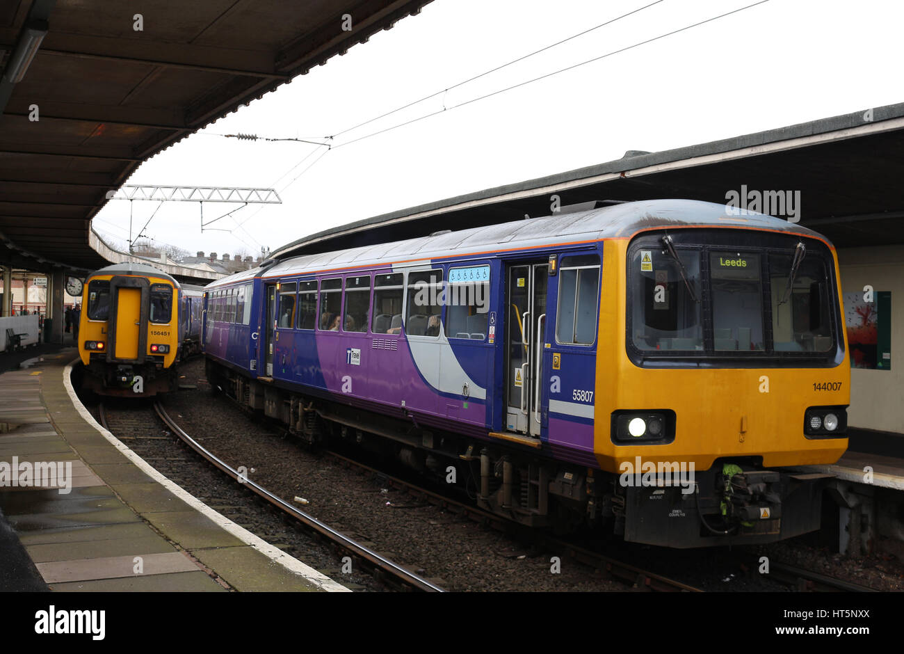 Diesel multiple unit trains in Carnforth railway station, one is a class156 Sprinter and the other a class 144 Pacer both operated by Northern. Stock Photo
