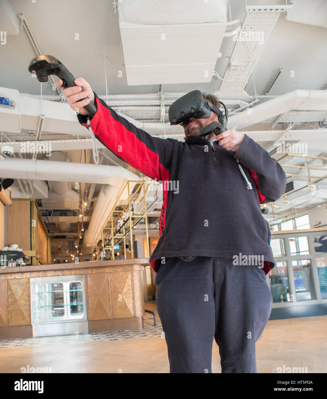 Virtual reality being experienced by a man while wearing headsets and ...