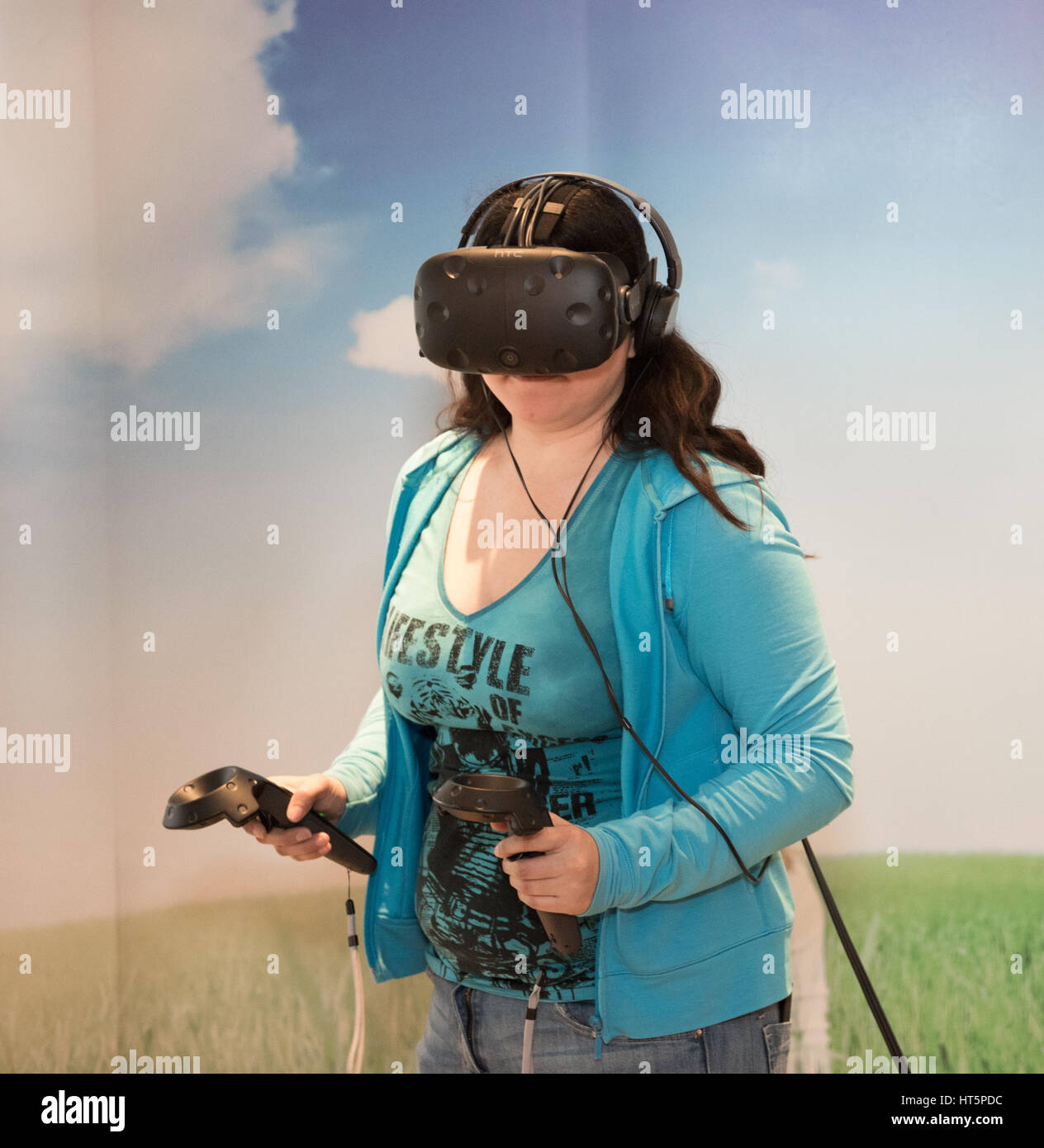 Virtual reality being experienced by a woman while wearing headsets and ...