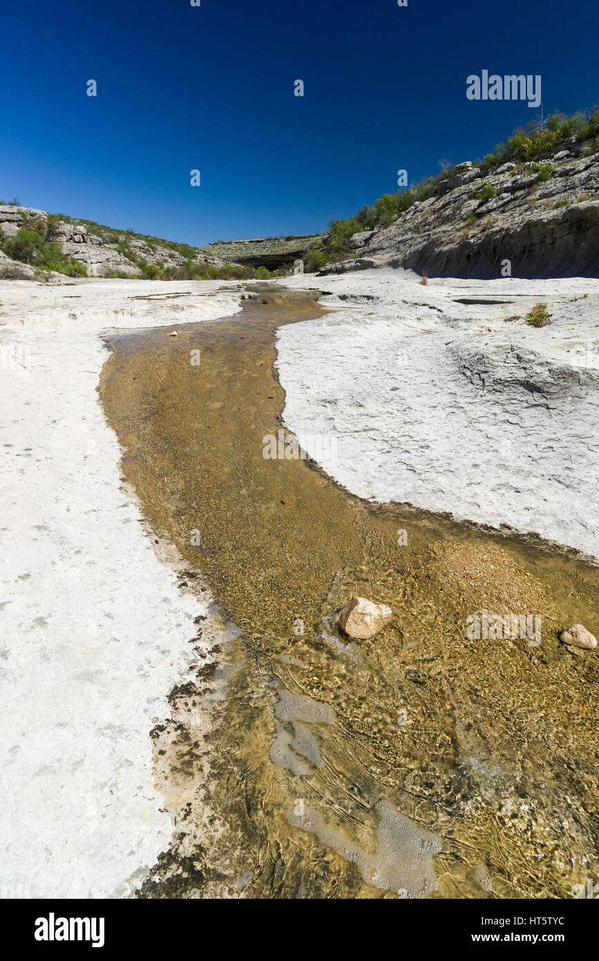 A small seasonal stream flows over dry rock in Seminole Canyon, Texas, USA Stock Photo