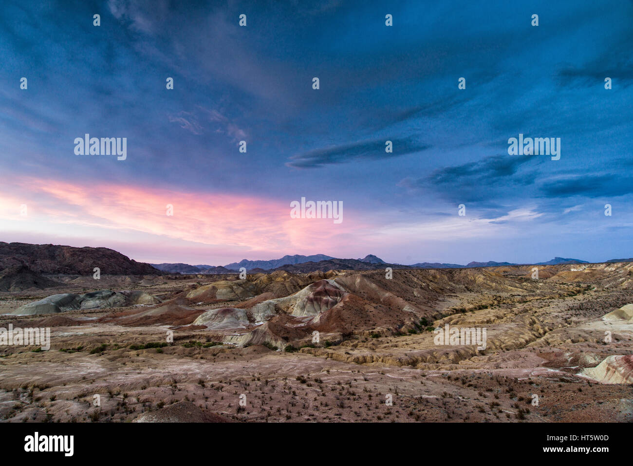 Big Bend Badlands landscape showing hills and mountains under pink sky at sunset, Texas Stock Photo