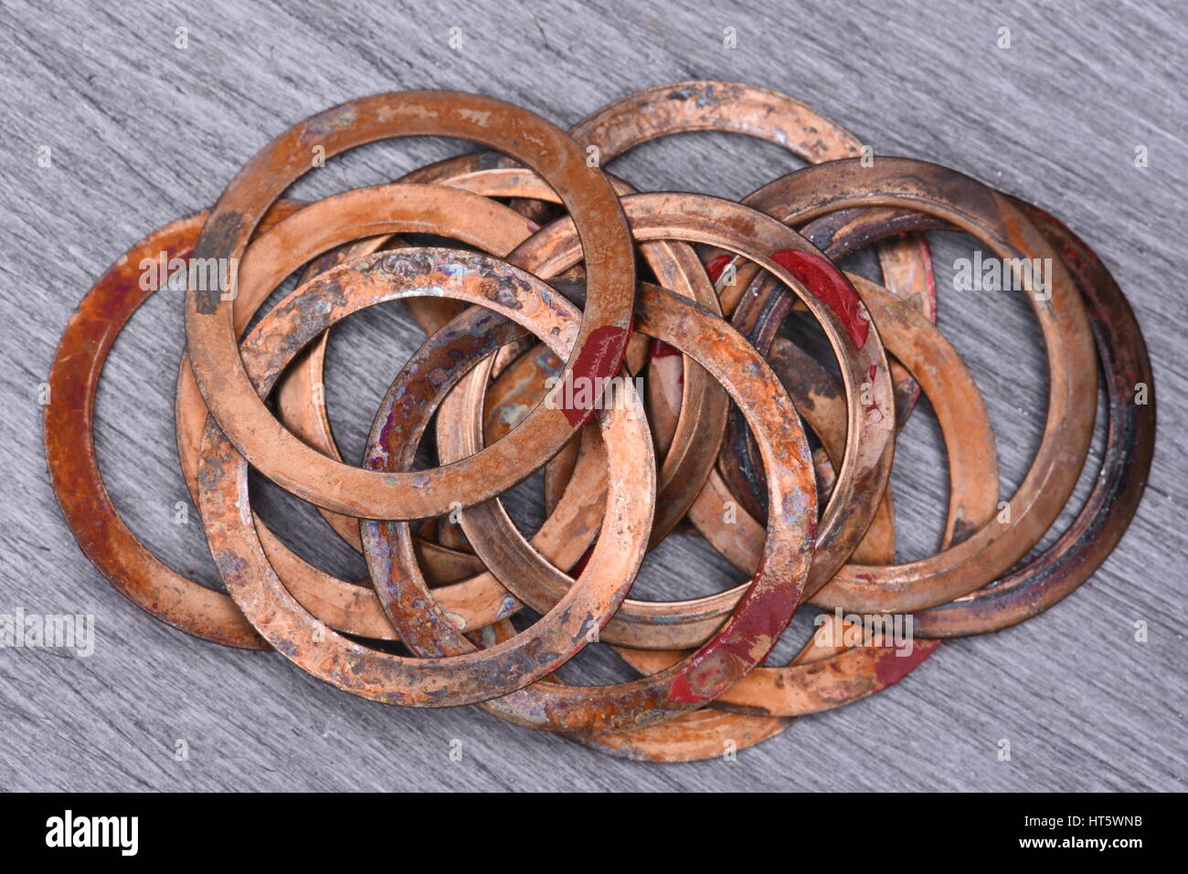 Old Copper Washers on Metal Background, Top View Stock Photo