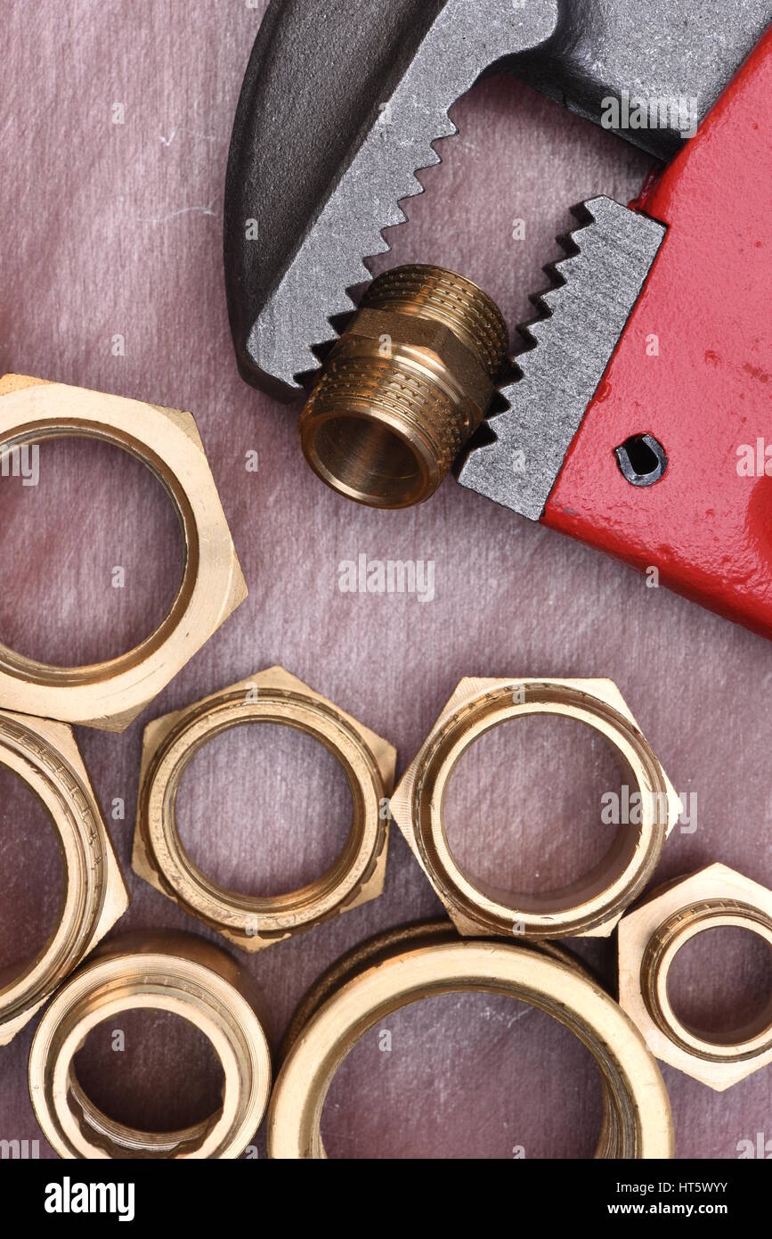 Wrench and brass fittings closeup Stock Photo