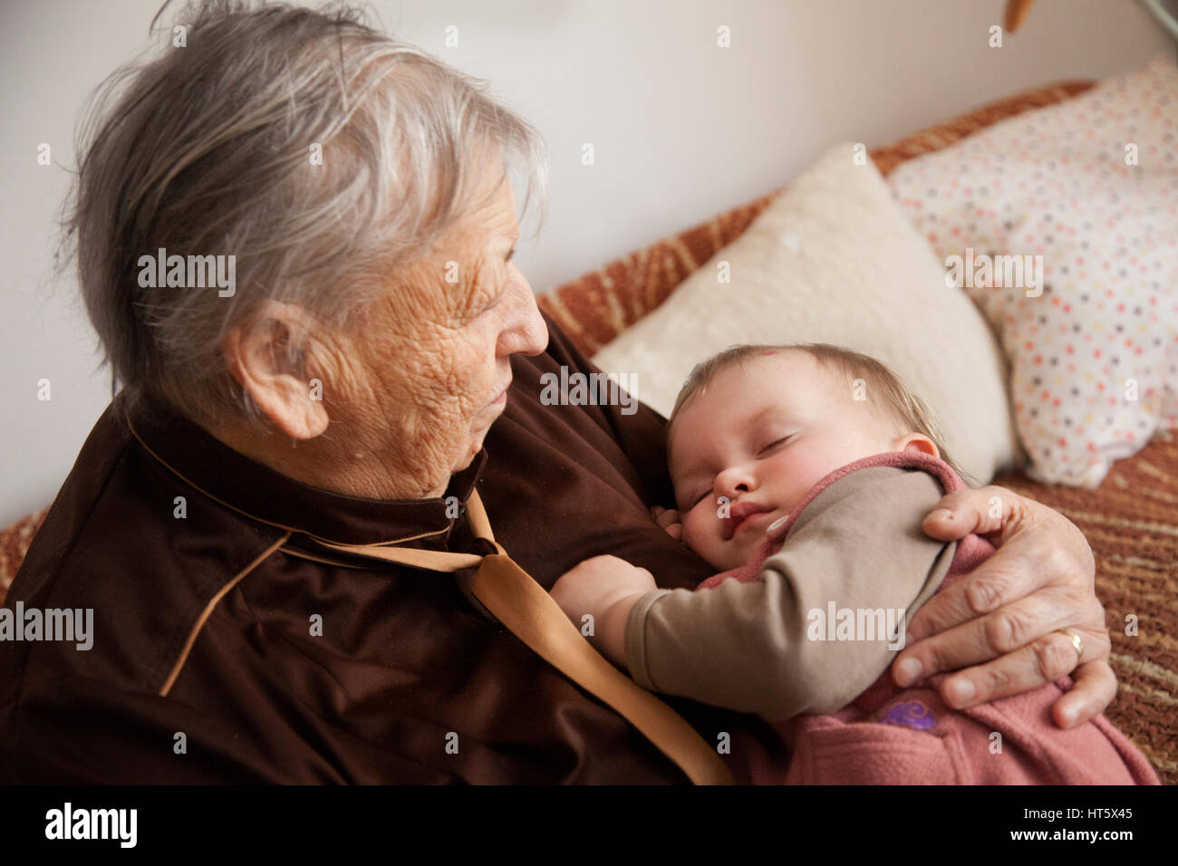 Grandma holding baby hi-res stock photography and images - Alamy