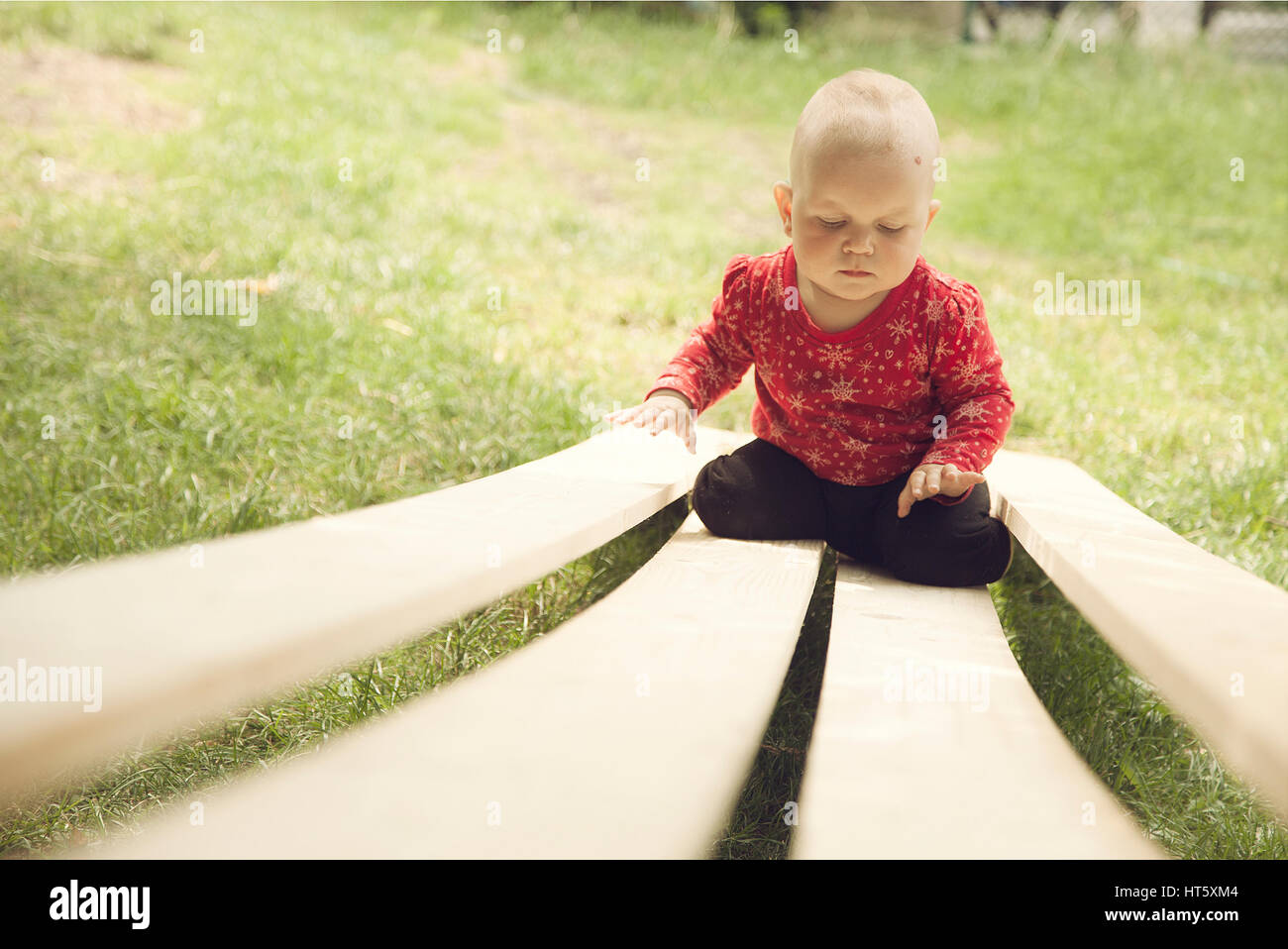 baby balancing on the woden planks Stock Photo - Alamy
