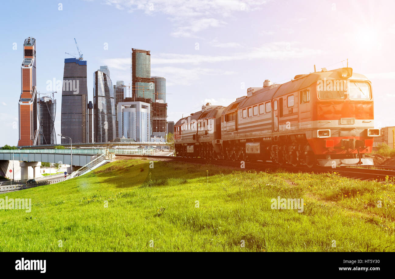 Green lawn and red train with Moscow-city on the background Stock Photo