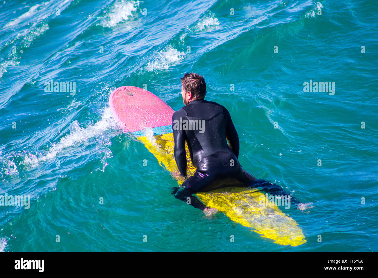 A surfer waiting for the good wave to come on pacific beach, San Diego