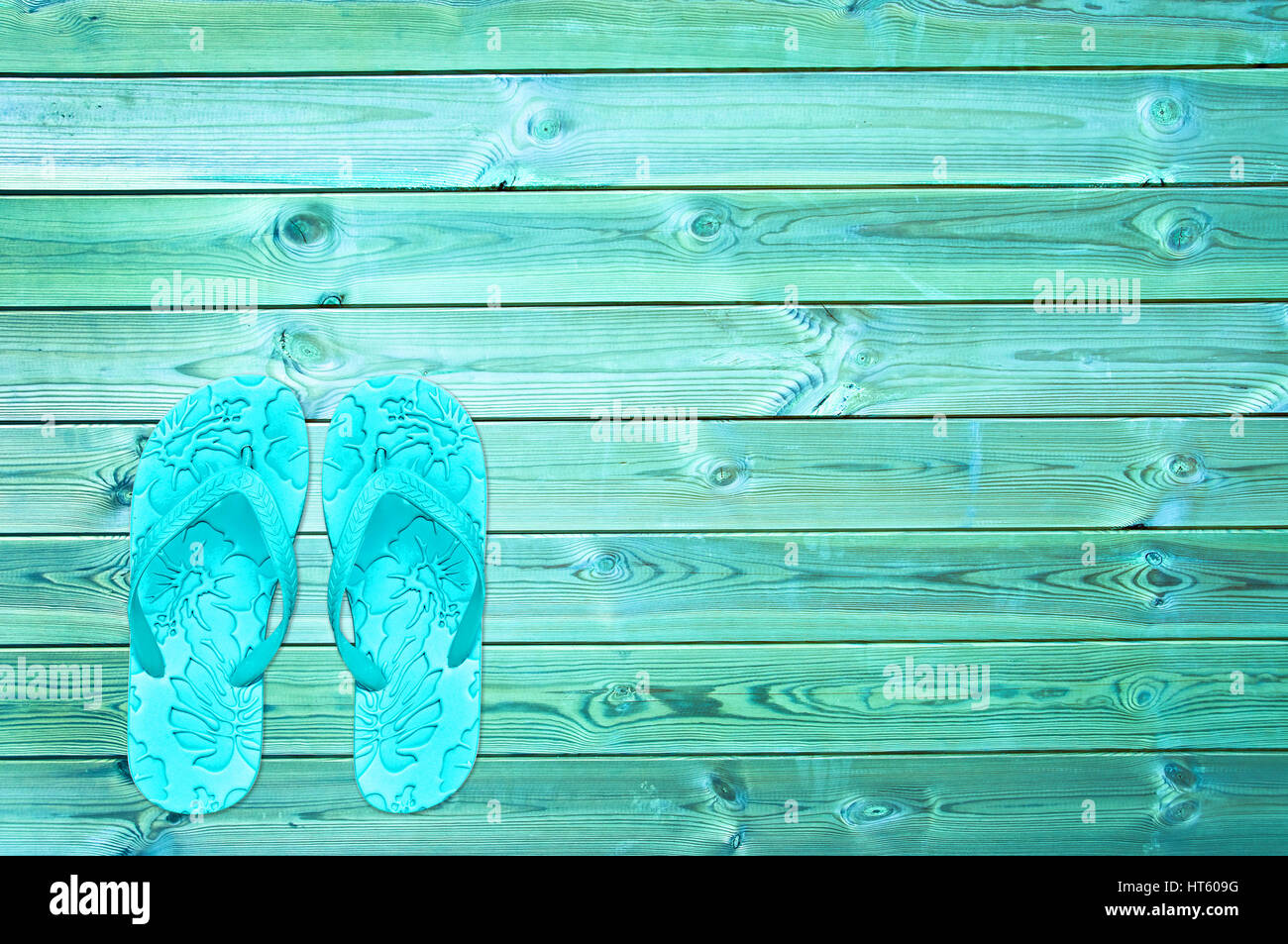 Blue flip-flops on wooden planks background Stock Photo