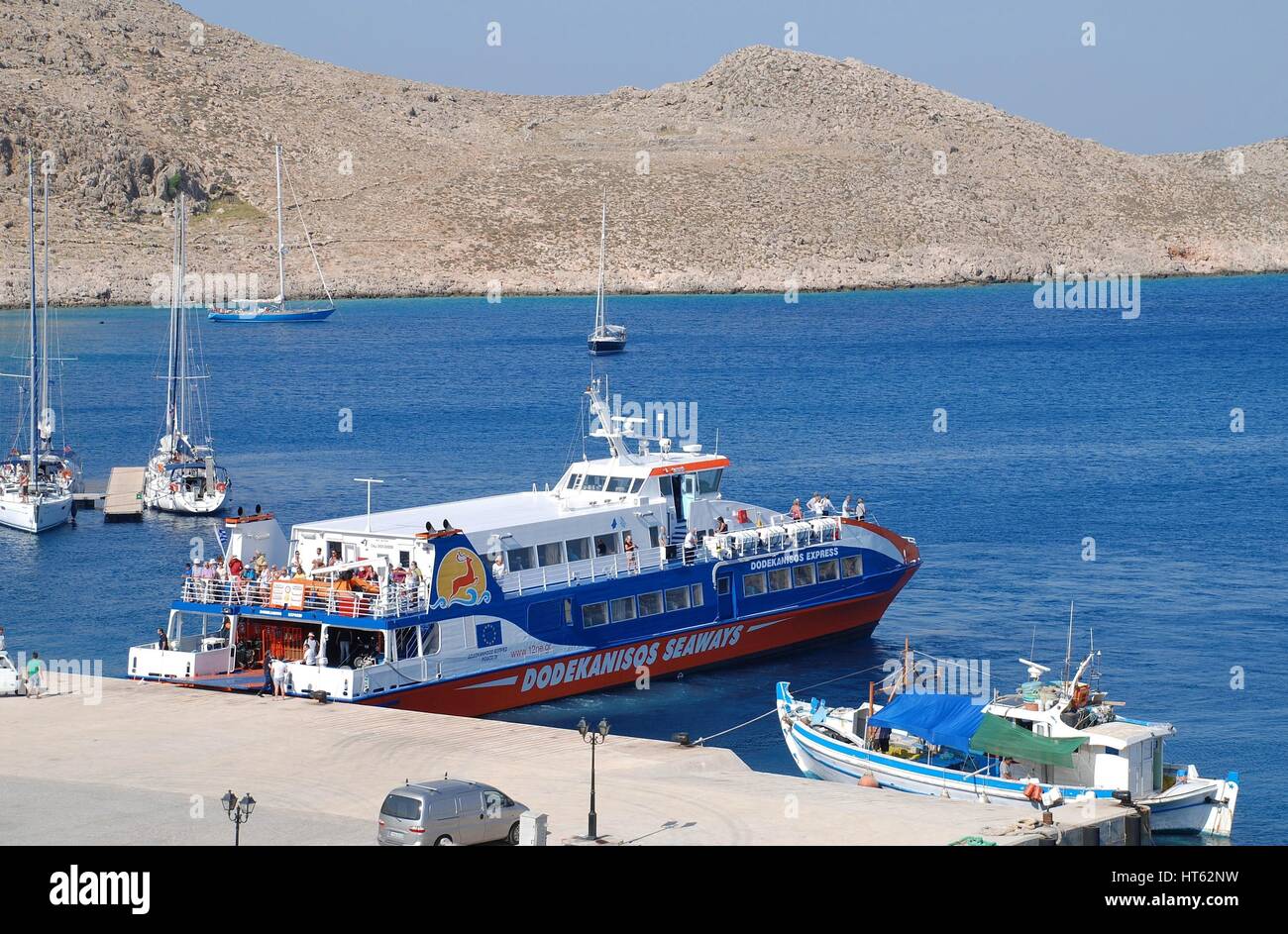 Dodekanisos Seaways catamaran ferry boat Dodekanisos Express docked at Emborio harbour on the Greek island of Halki. The  vessel was built in Norway. Stock Photo