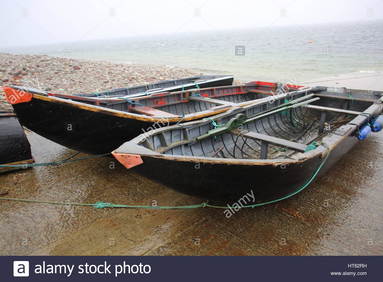 Two small fishing boats tied up on the shore in County Mayo , Ireland Stock Photo
