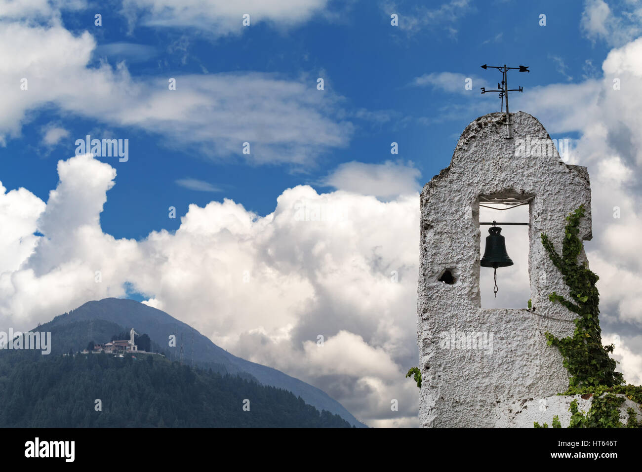 An old bell tower with Cerro de Guadalupe in the background in Bogota, Colombia. Stock Photo