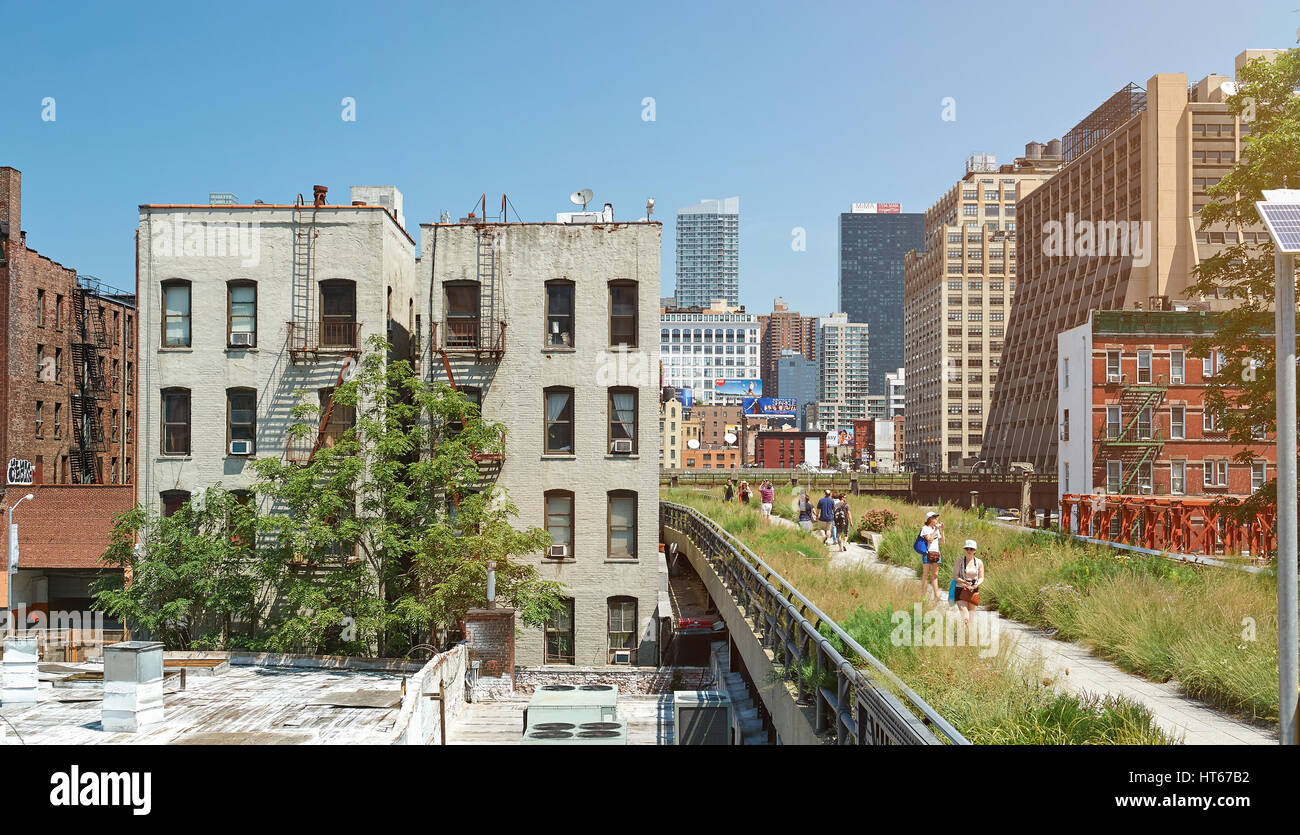 New York, Nicaragua - August 12, 2012: Modern highline park in New York city. People walking on urban park on sunny day around skyscrapers Stock Photo