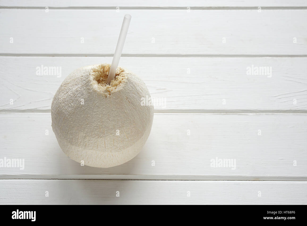 fresh coconut with drinking straw Stock Photo