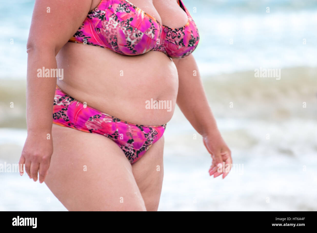 Obese woman in a swimsuit. Lady with fat belly. Negative impact of  sedentary lifestyle. Don't put health at risk Stock Photo - Alamy