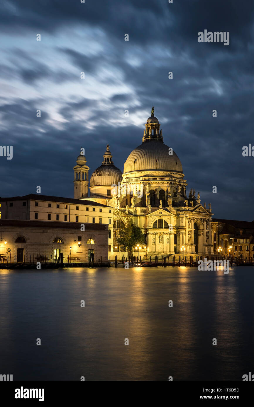Sunset long exposre across Grand Canal to Basilica di Santa Maria della Salute in Venice, Italy with dramatic skies and beautiful lighting Stock Photo