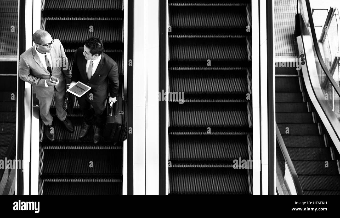 Business Men Talk Tablet Escalator Stock Photo