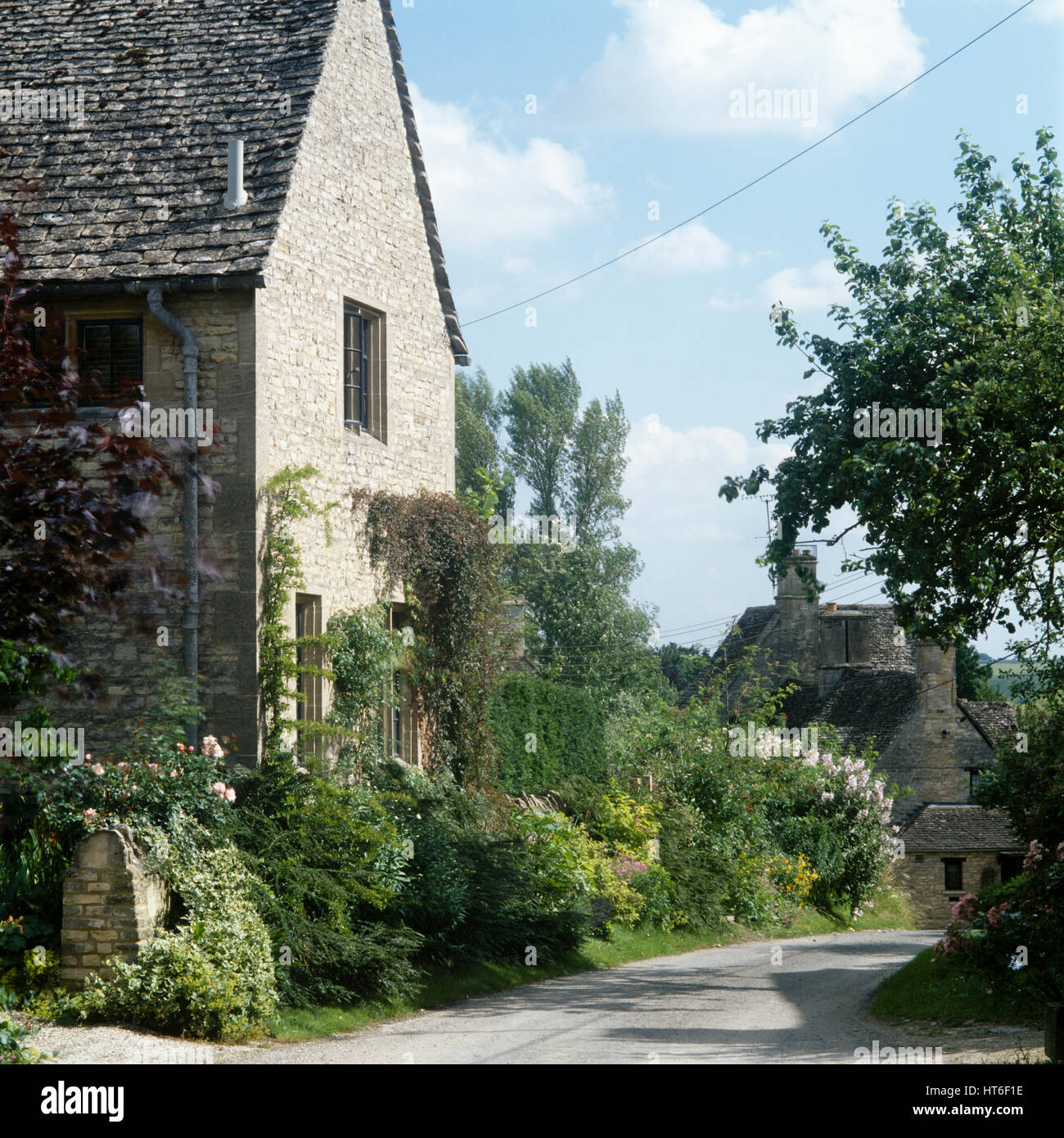Stone house by a road. Stock Photo