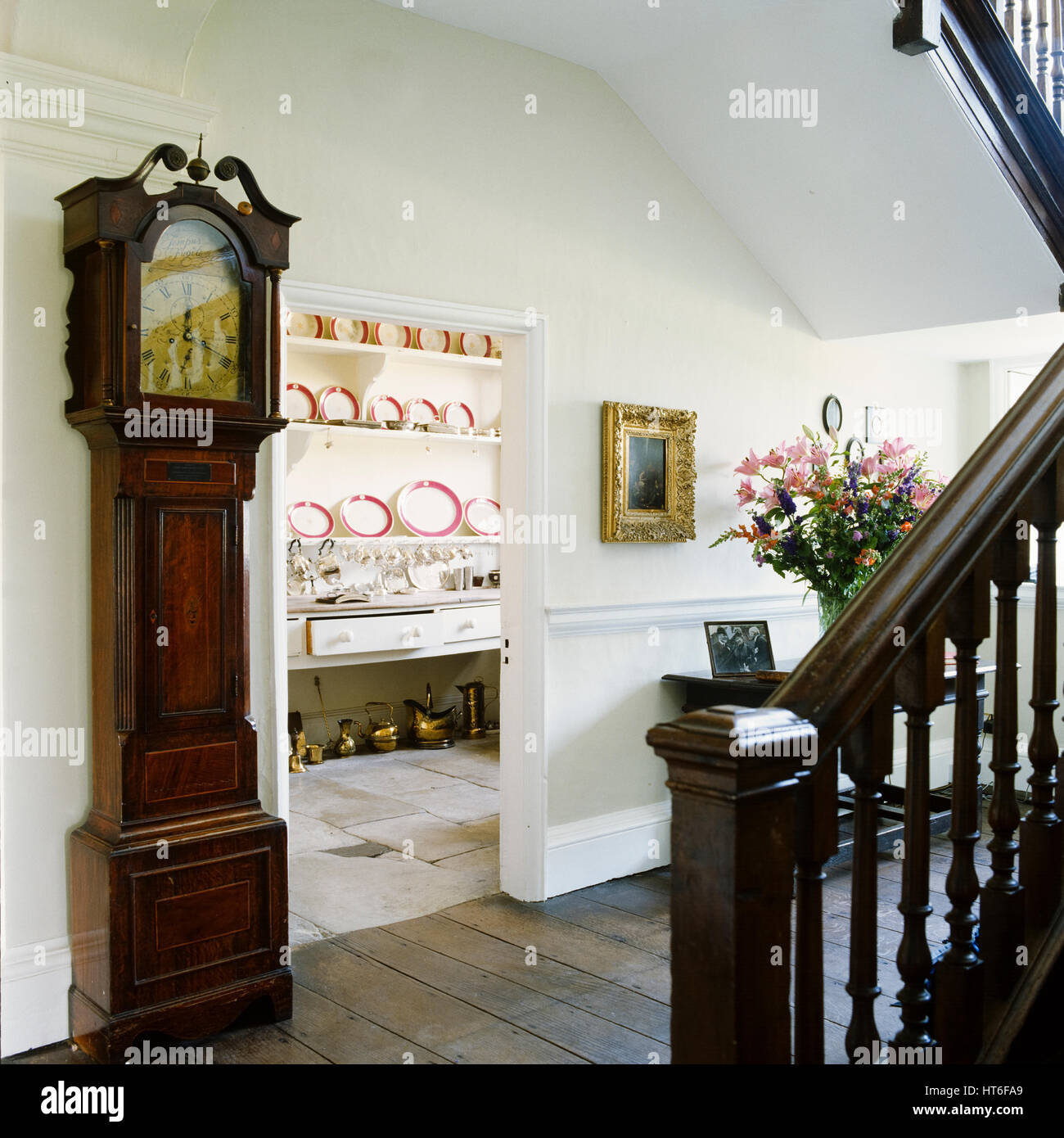 Grandfather clock by staircase. Stock Photo