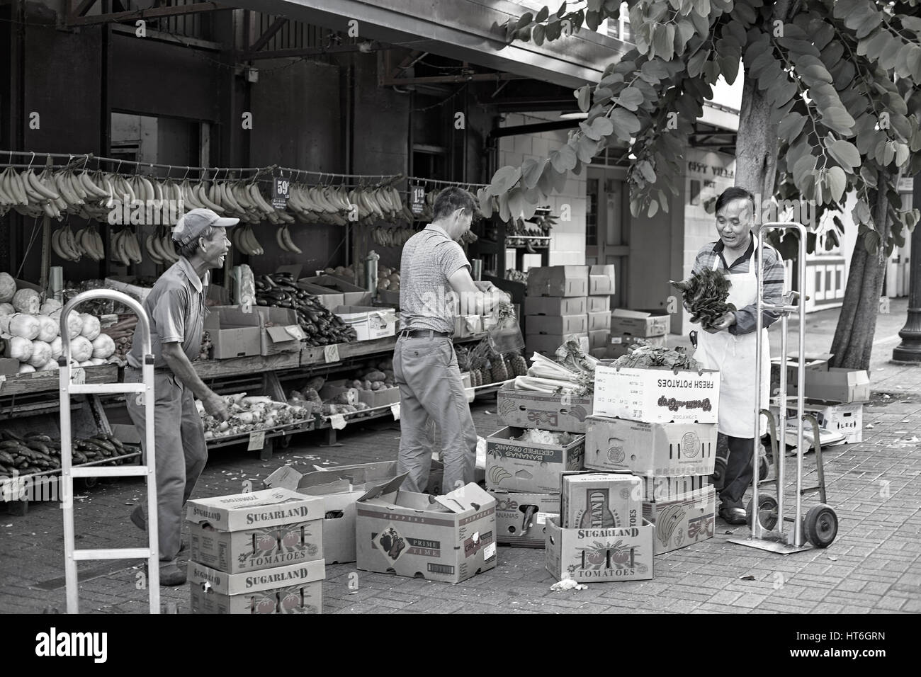Honolulu; Hawaii; USA - August 6; 2016: Men working in Chinatown Historic District; a popular local destination and tourist attraction. Stock Photo