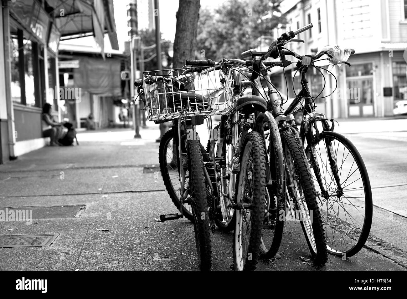 Honolulu, Hawaii - August 6, 2016: A row of locked bicycles on a sidewalk in downtown historic Chinatown. Stock Photo