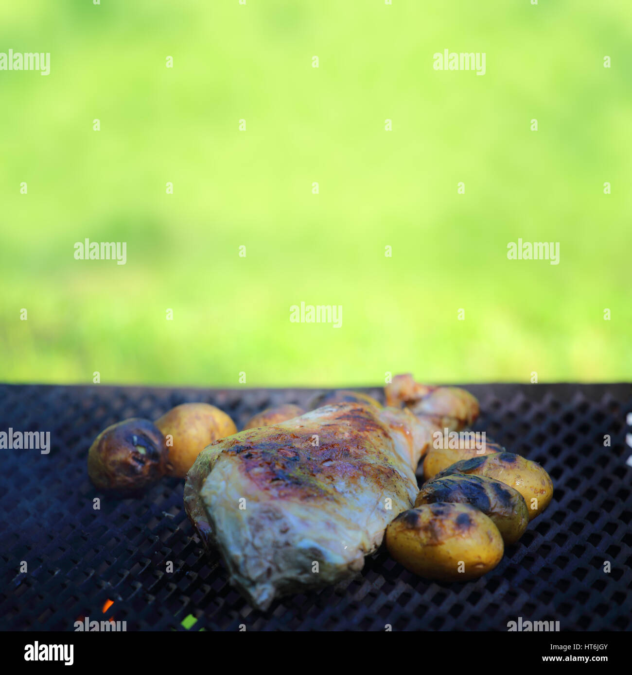 Baking lamb leg and potatoes on grill outdoors Stock Photo Alamy