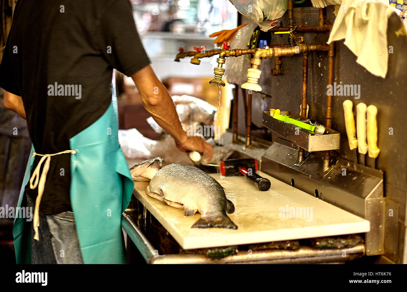 Honolulu; Hawaii; USA - August 6; 2016: Chinatown fish cutter in blur of motion in the Chinatown Historic District; a popular local destination and to Stock Photo
