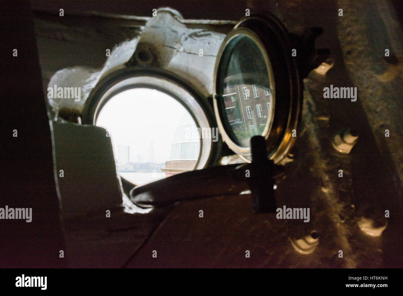 River Thames, Greenwich, London, viewed through a porthole in the Cutty Sark, tea clipper. Stock Photo