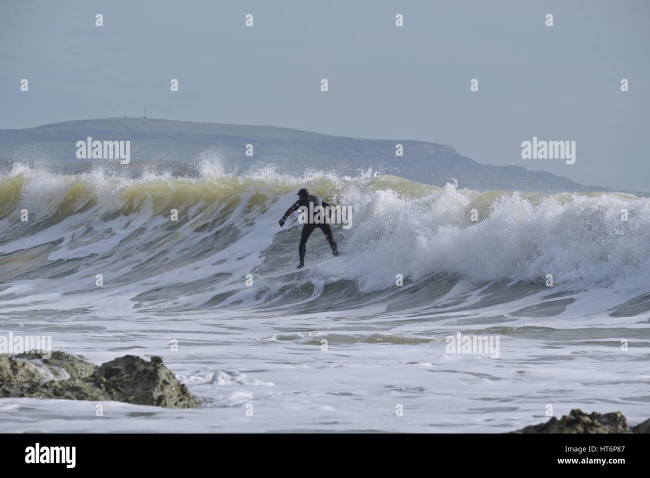 surfing at Freshwater Bay, Isle of Wight with rocks in the foreground Stock Photo Alamy