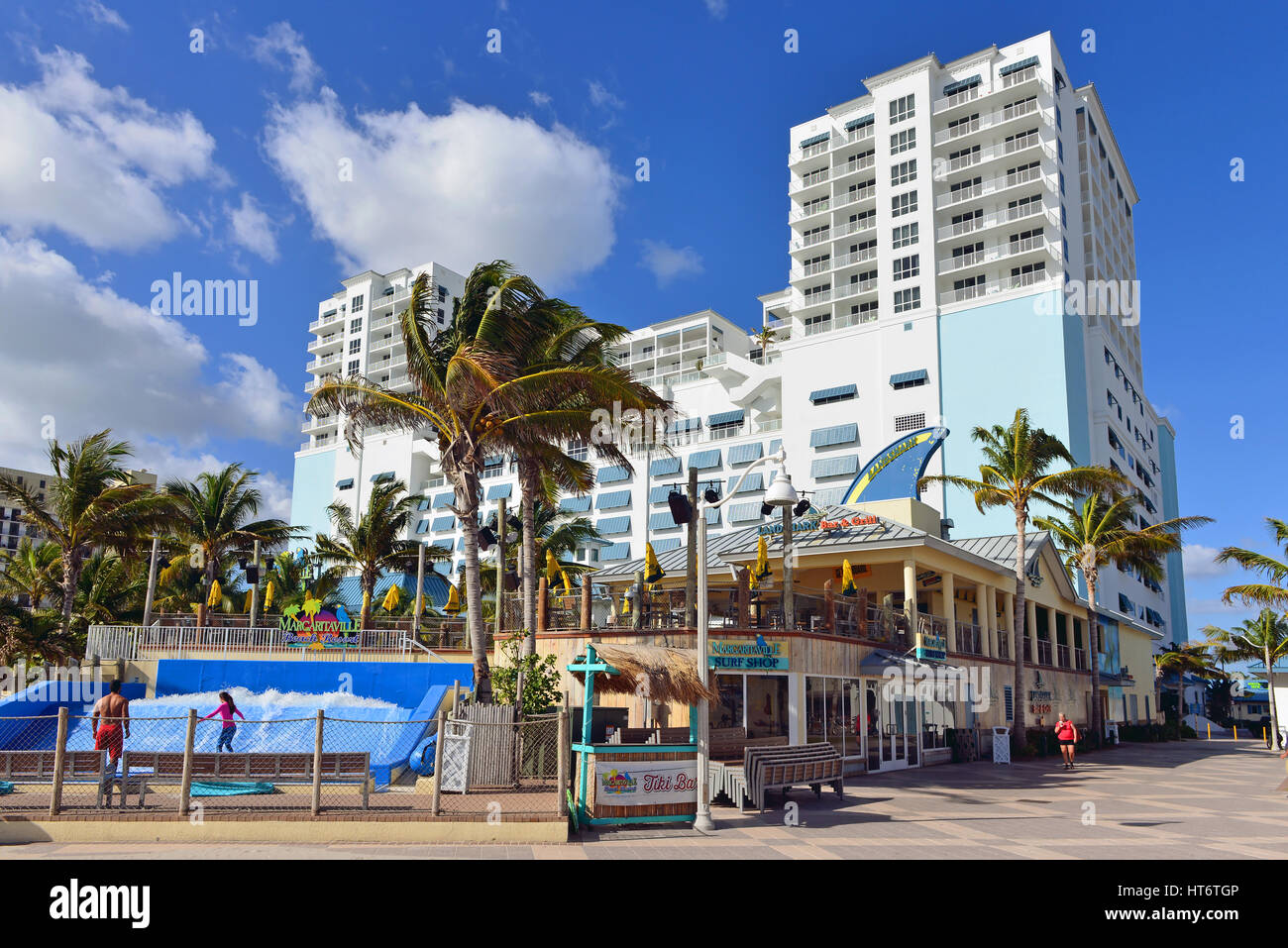 Hollywood Beach, FL, USA - People enjoy the FlowRider surf simulator the Margaritaville Beach Resort.  Margaritaville is a popular chain of restaurant Stock Photo