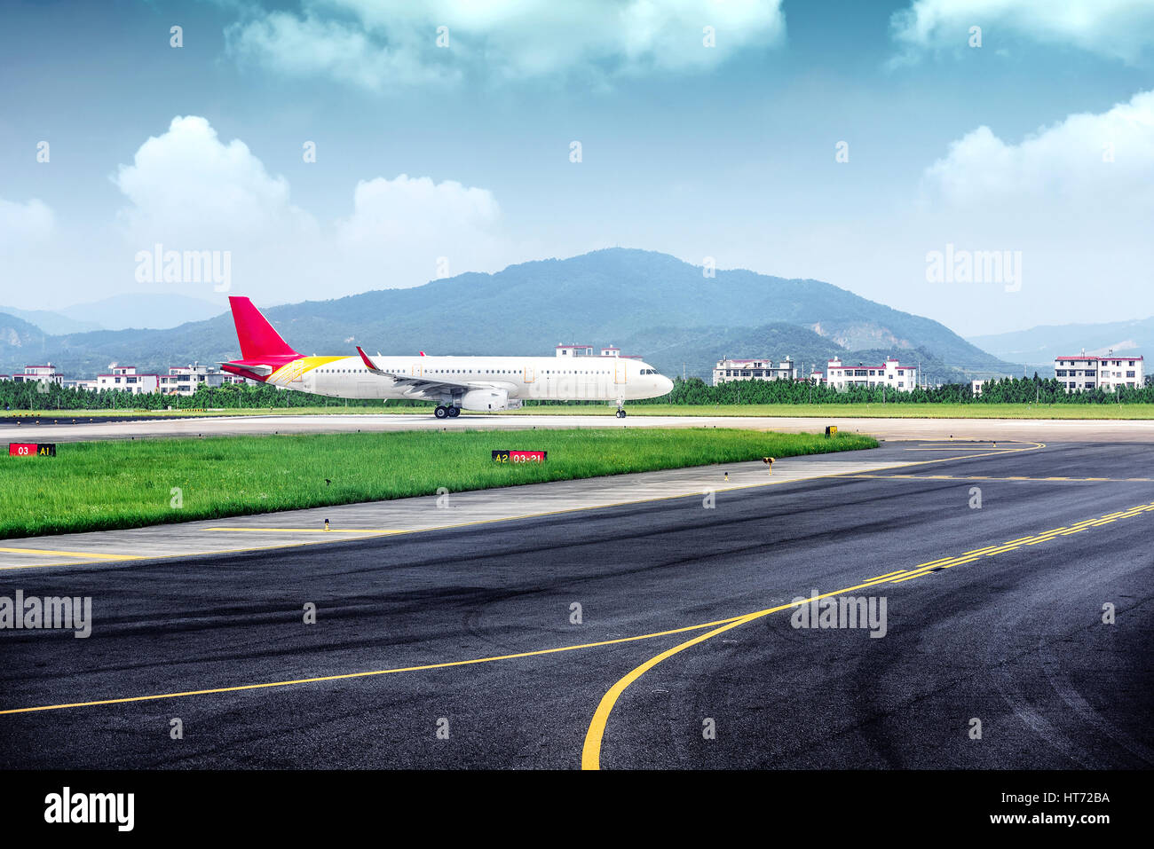 vehicles and ariplane parking in airport ramp in cloudy sky Stock Photo