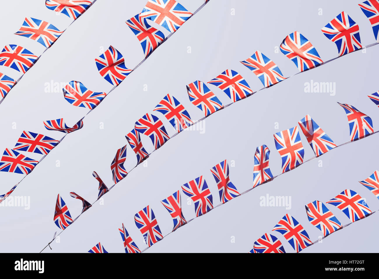 UK Union flag bunting flapping in the wind Stock Photo