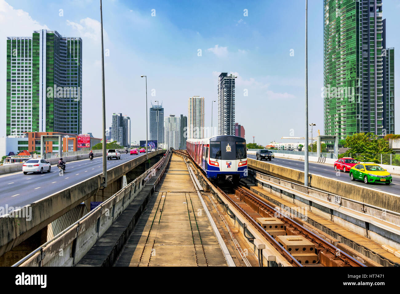 BANGKOK, THAILAND - JANUARY 30: BTS Sky train arriving in Saphan Taksin station on Taksin bridge with city buildings and roads on each side on January Stock Photo