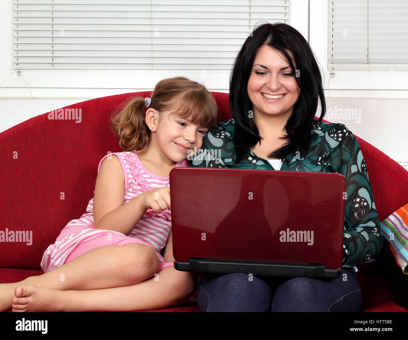 little girl and woman with laptop Stock Photo - Alamy