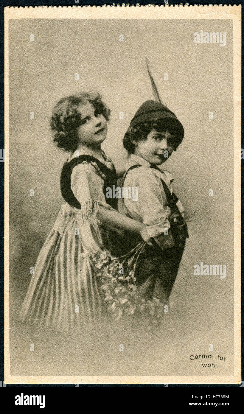 GERMANY - CIRCA 1914: A promotional postcard (Carmol tut wohl) printed in Germany, shows a boy and a girl in traditional Bavarian dress, circa 1914 Stock Photo