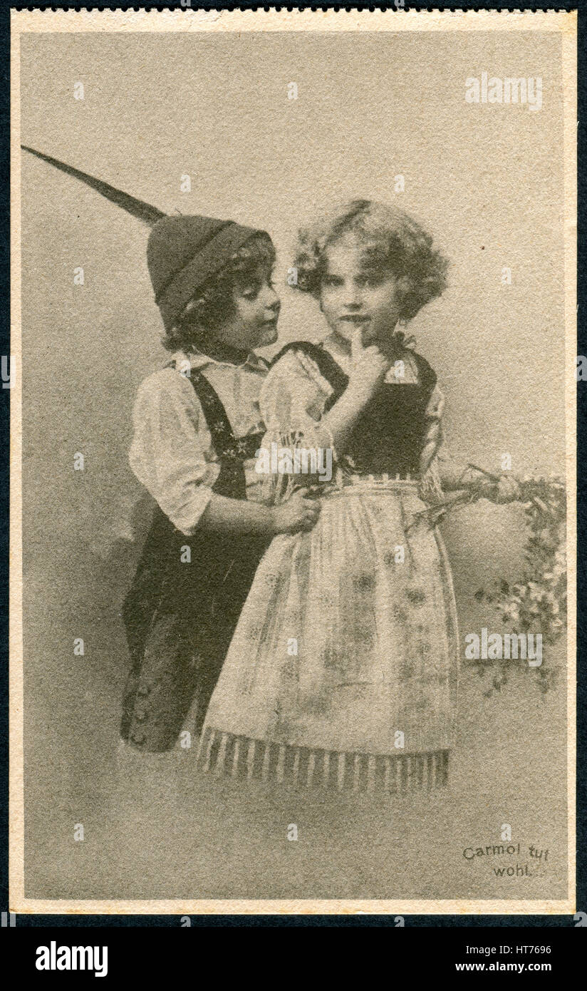 GERMANY - CIRCA 1914: A promotional postcard (Carmol tut wohl) printed in Germany, shows a boy and a girl in traditional Bavarian dress, circa 1914 Stock Photo