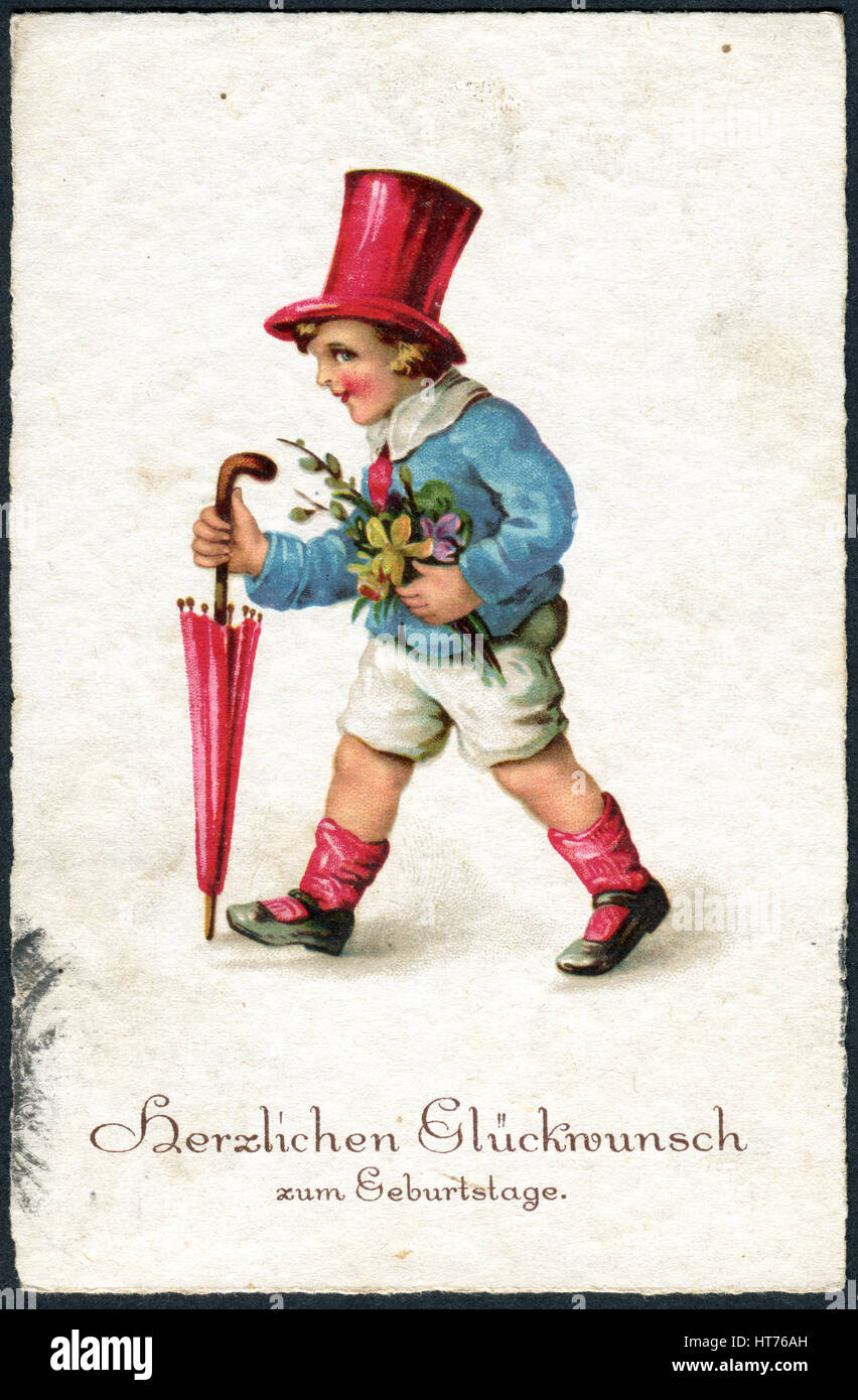 GERMANY - CIRCA 1934: A greeting postcard printed in Germany, shows a boy with flowers. The inscription in German: Happy birthday, circa 1934 Stock Photo