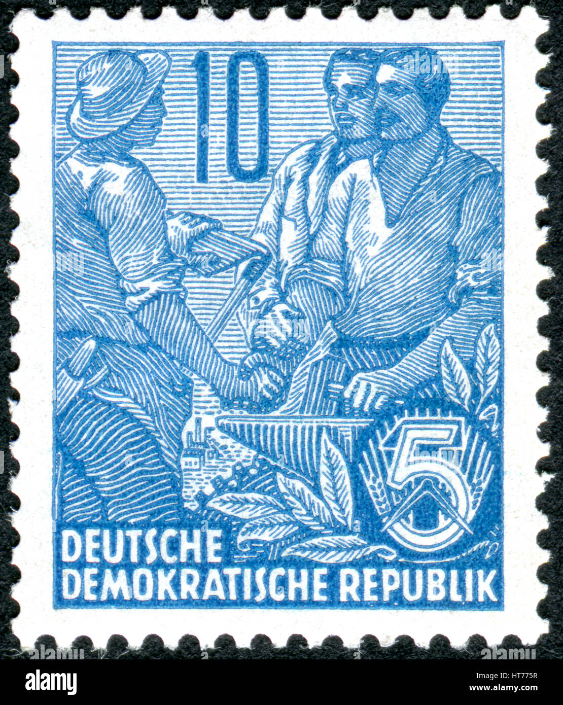 GERMANY - CIRCA 1955: A stamp printed in Germany (GDR), is dedicated to the five-year plan, shows worker, peasant and intellectual, circa 1955 Stock Photo
