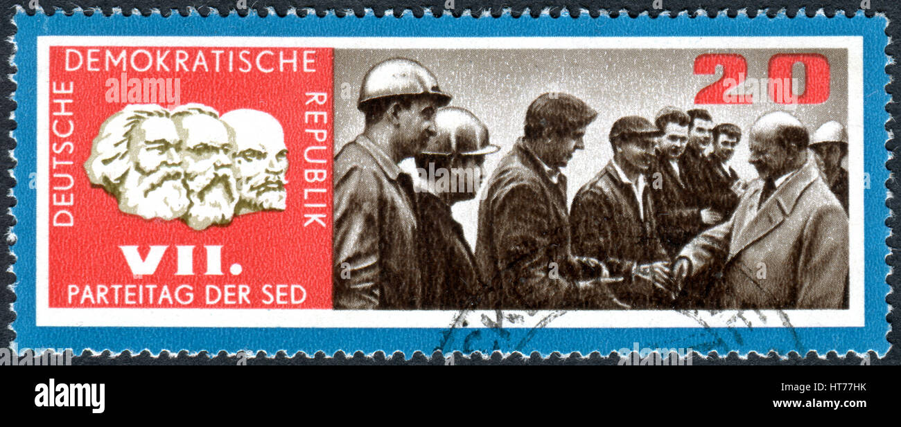 A stamp printed in Germany (GDR), dedicated to 7th congress of Socialist Unity Party of Germany, shows the Walter Ulbricht and factory workers Stock Photo