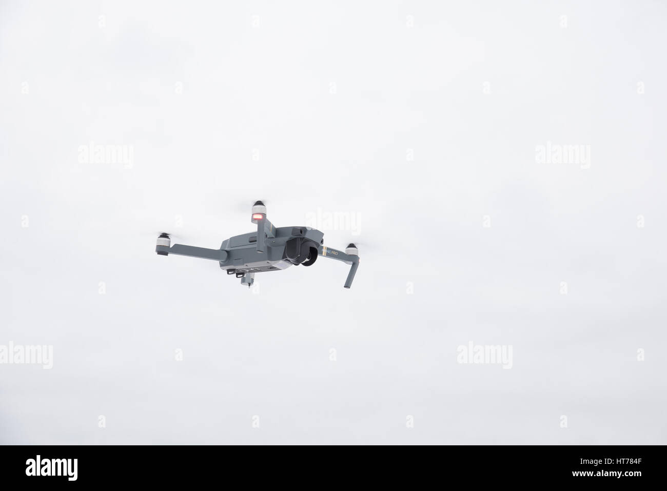 DJI Mavic Pro drone: Latvia March 8, 2017. Closeup of flying drone. Background of the blue sky. One of the most portable drones in the market,with 4k Stock Photo