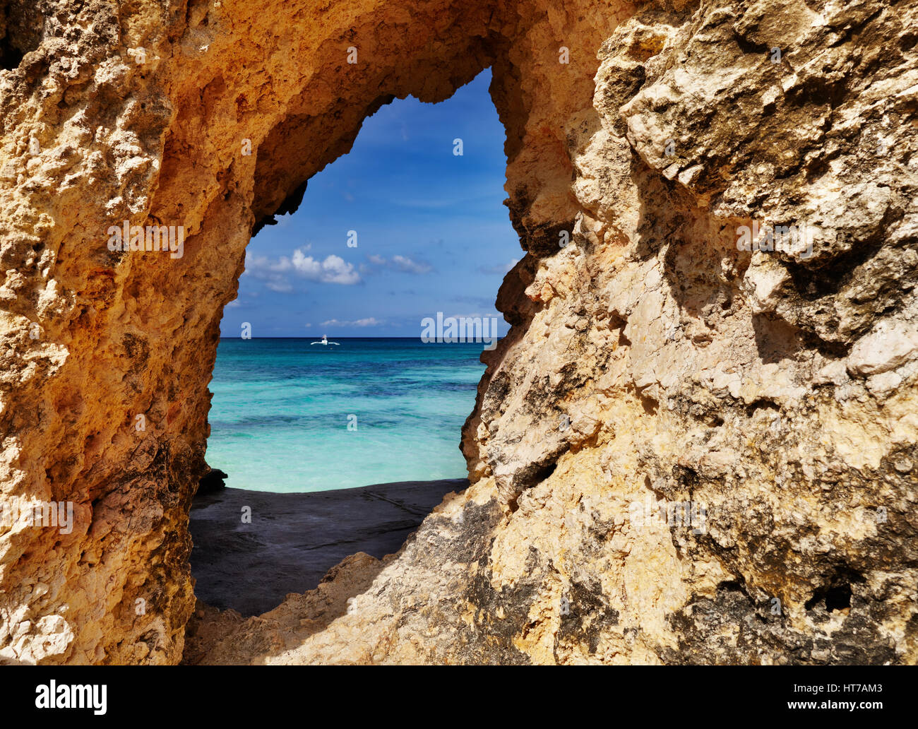 Tropical beach, view through a hole in the rock, Boracay island, Philippines Stock Photo