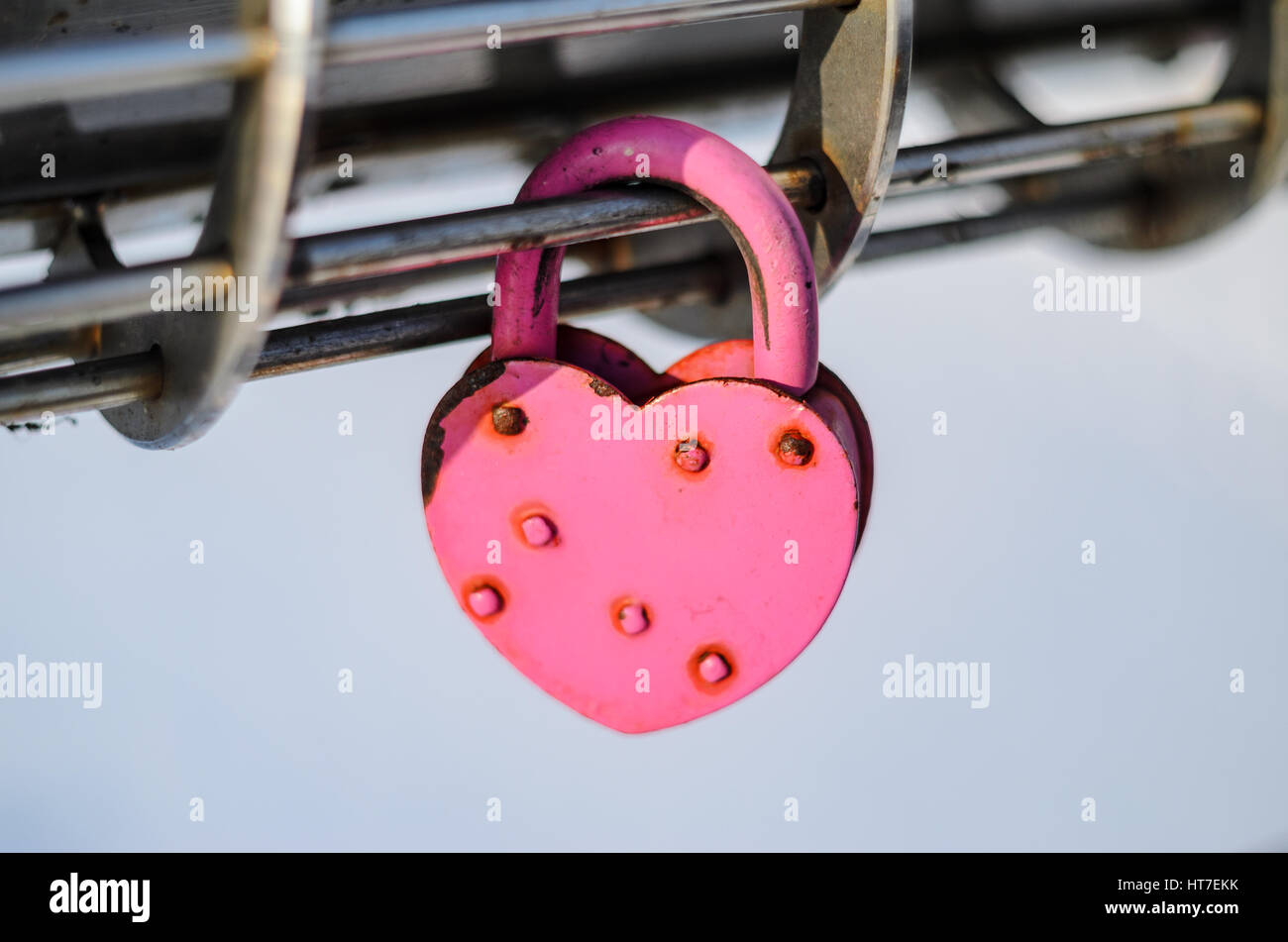 Pink Padlock in the shape of heart on modern steel chrome railing Stock ...