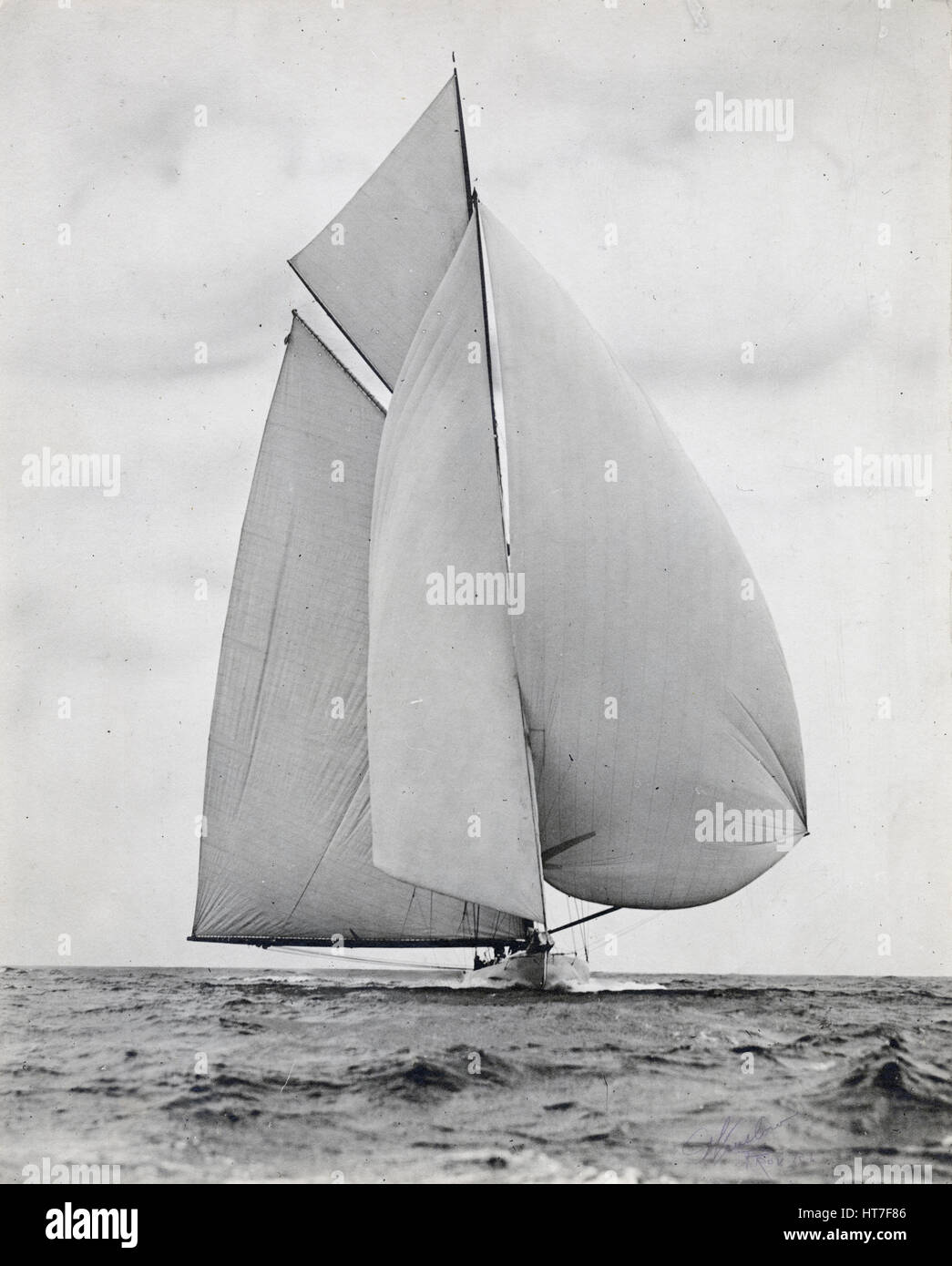 Antique c1900 photograph, unknown yacht belonging to Charles Oliver Iselin. Iselin (1854-1932) was an American banker and yachtsman. He participated in and won six consecutive America’s Cup races in 1887, 1893, 1895, 1899, 1901 and 1903. He owned yachts 'Defender,' 'Reliance,' 'Columbia' and others. Photograph by Winslow of Providence, Rhode Island. SOURCE: ORIGINAL SILVER GELATIN PRINT. Stock Photo