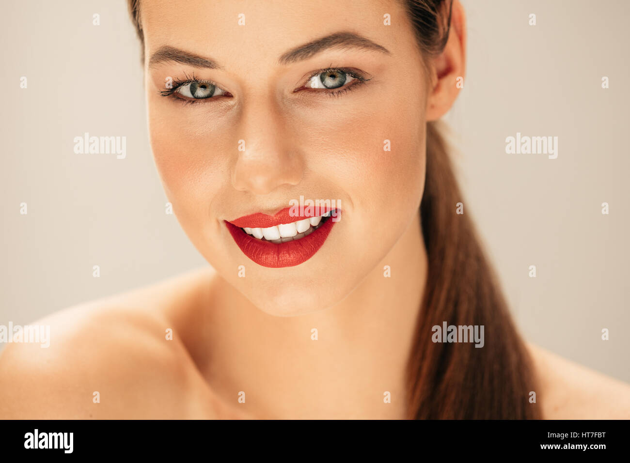 Close up portrait of caucasian female model with beautiful makeup. Young woman with perfect skin in studio. Stock Photo